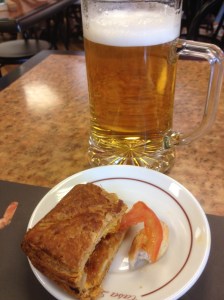 Half-eaten tapas and a refreshing cold beer